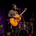 A man smiling on stage