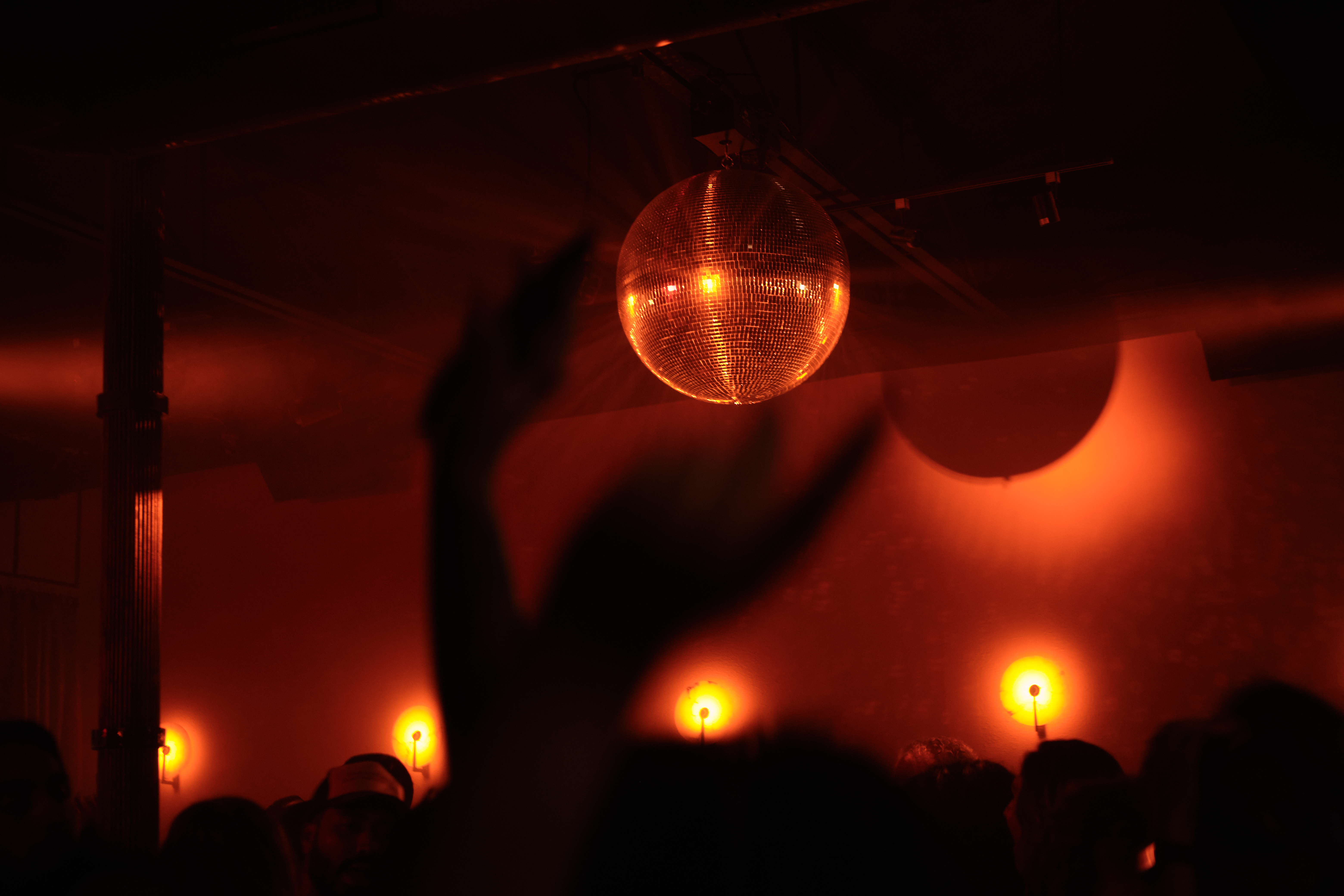 A crowd underneath a disco ball
