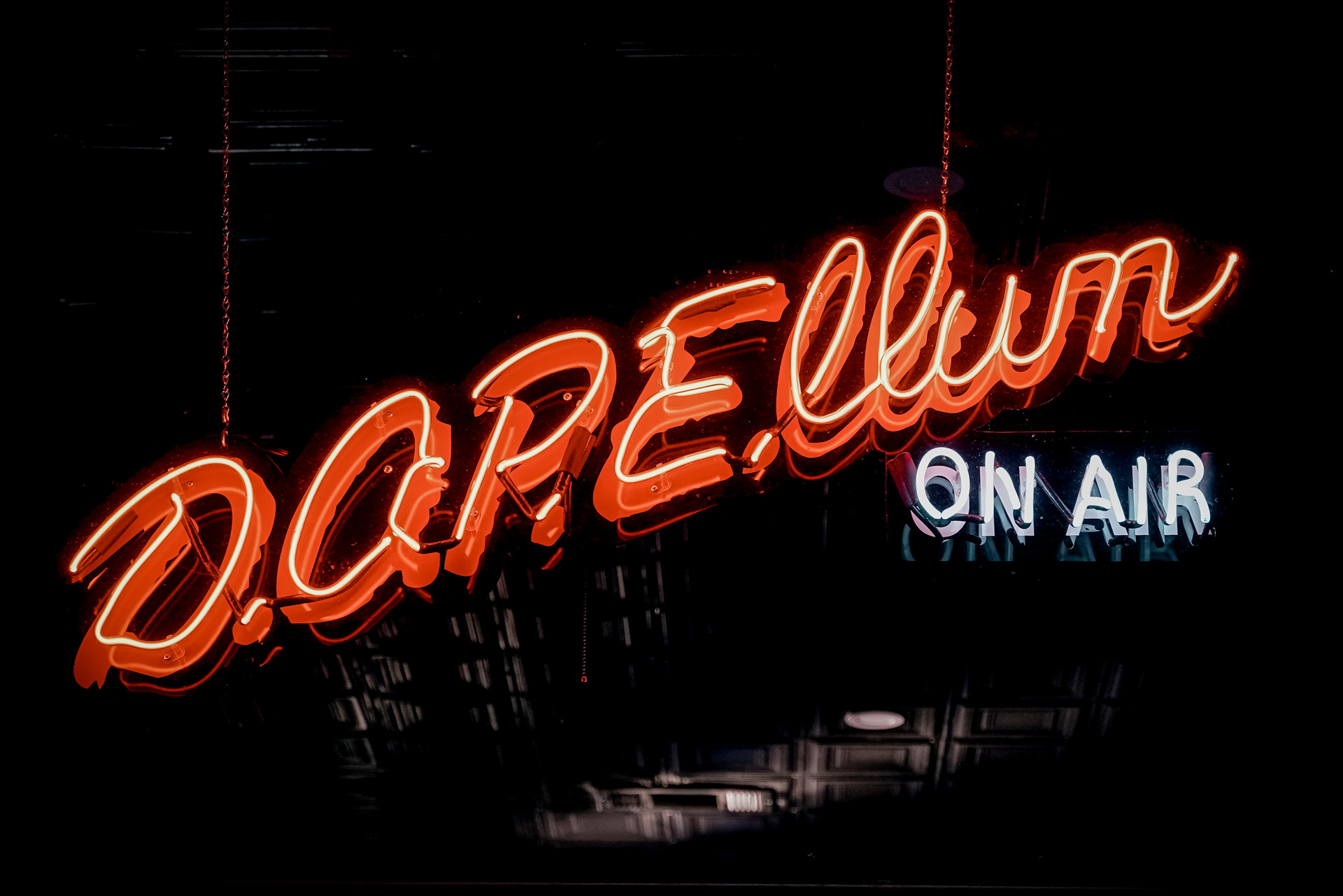 A neon sign that says "D.O.P.E. Ellum on air"