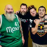 Bowling for Soup poses in front of a yellow wall