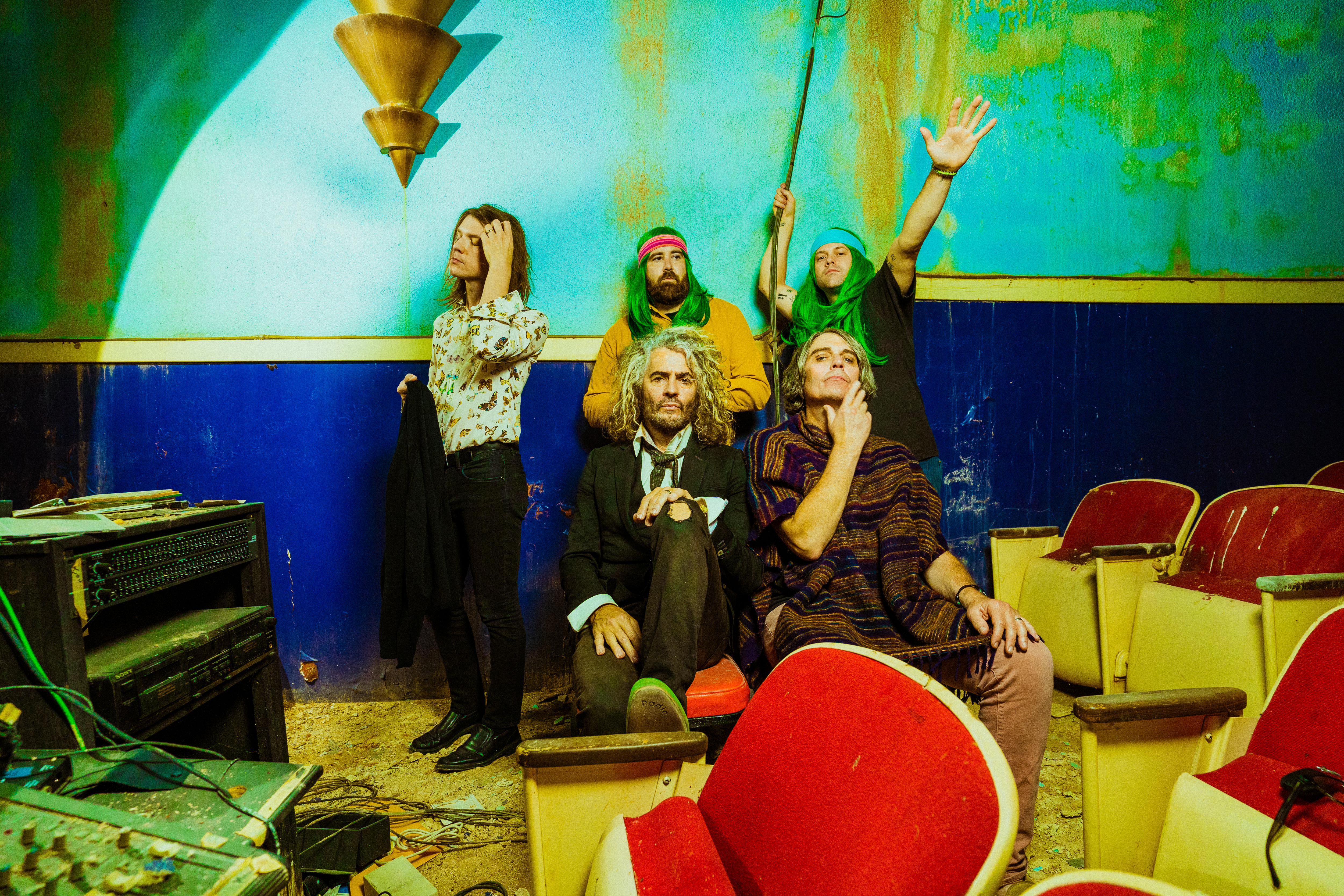 The Flaming Lips pose in an empty movie theater
