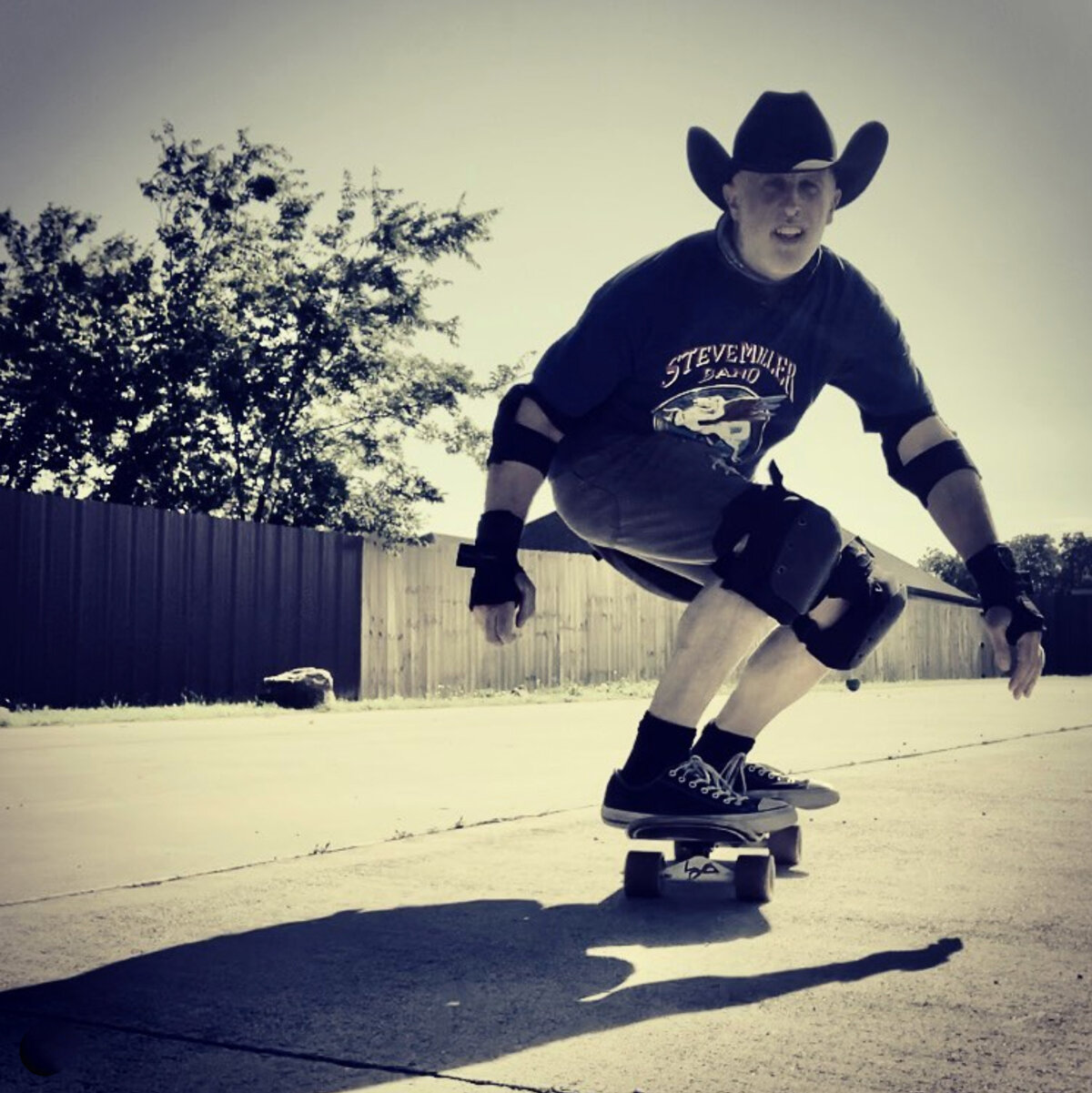 GW Childs IV rides a skateboard, wearing a black cowboy hat