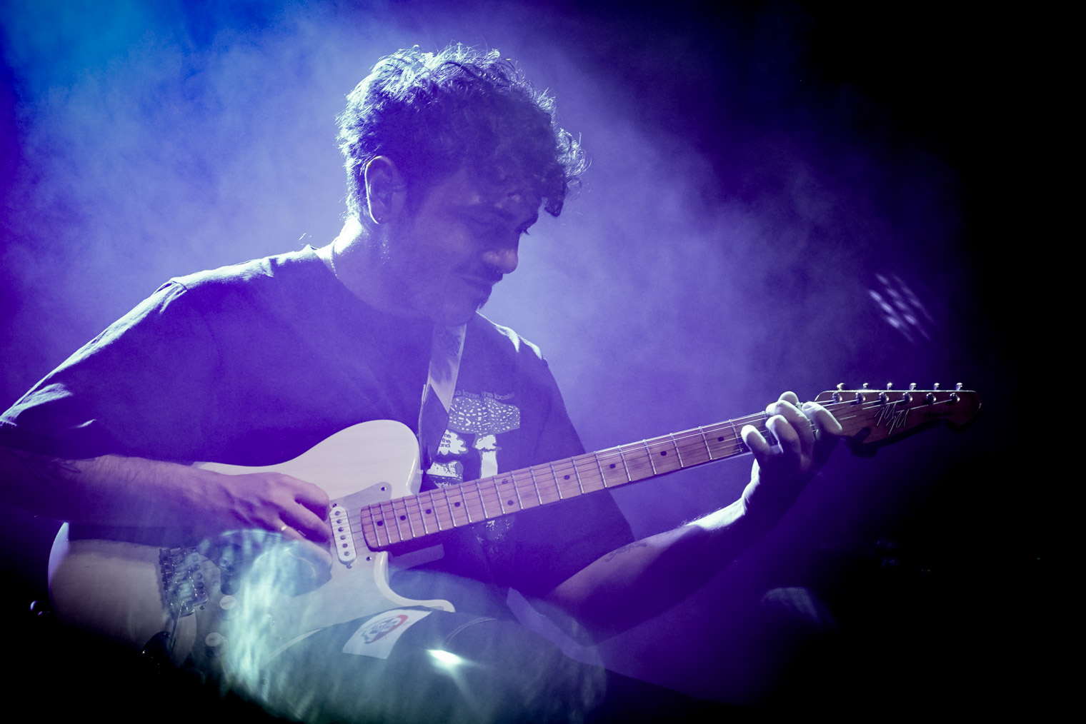 A musician playing guitar on stage