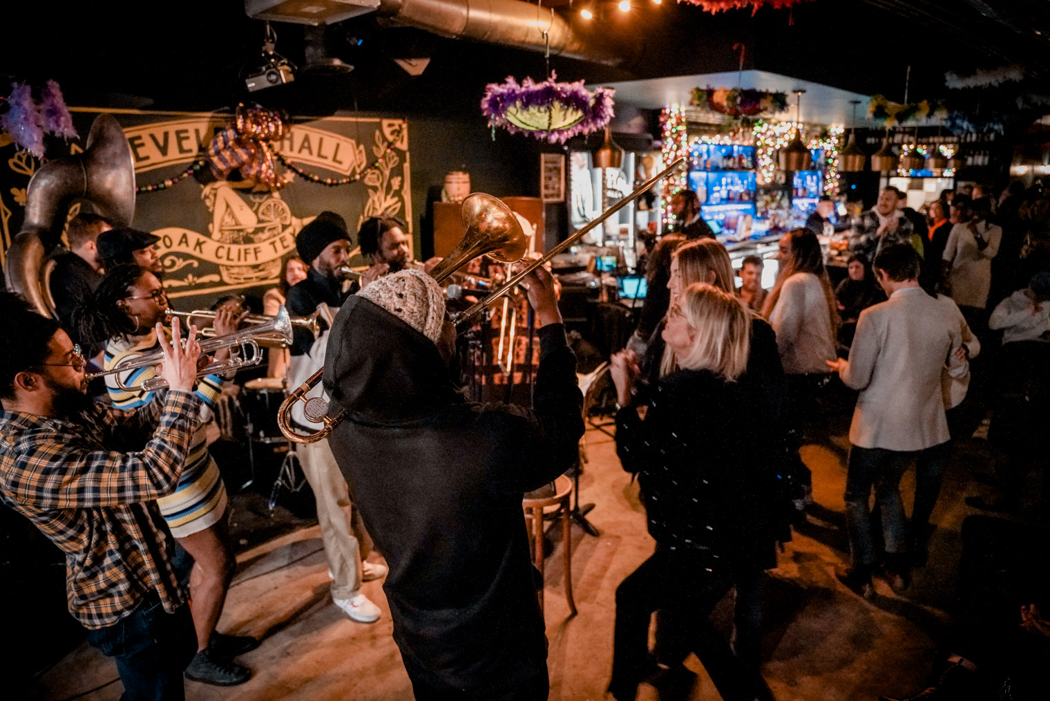 People playing music, people dancing inside a small venue