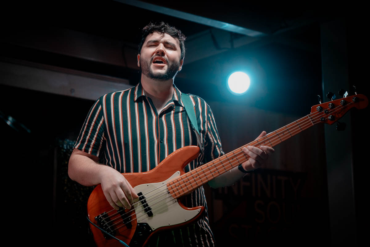 A musician playing bass on stage