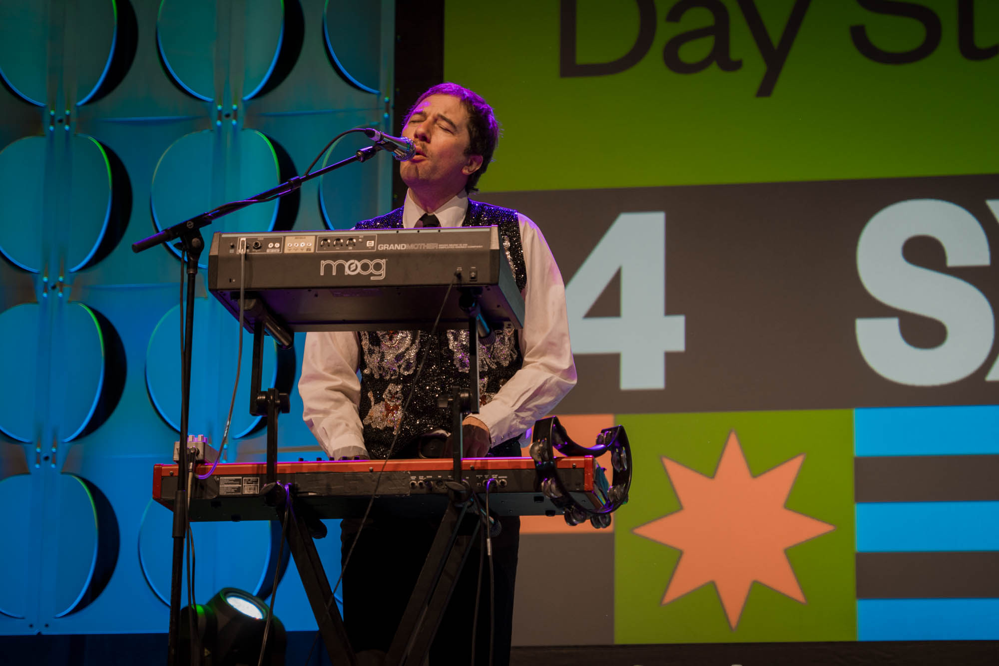 A musician playing keys on stage