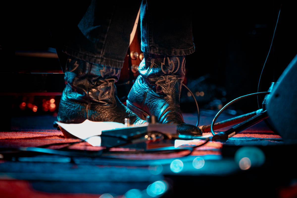 A photo of a musician's boots on stage