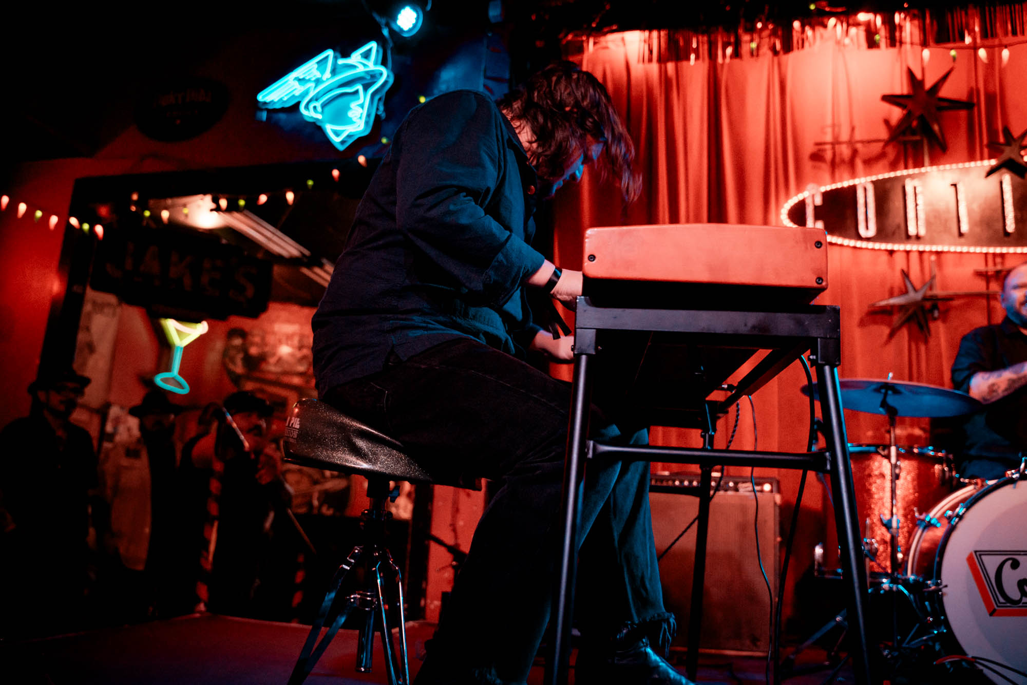 A musician playing keyboard on stage